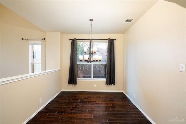 unfurnished dining area with a notable chandelier and vaulted ceiling