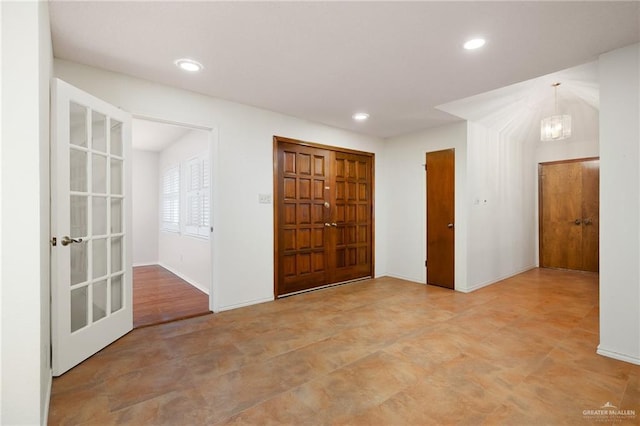 entrance foyer featuring an inviting chandelier