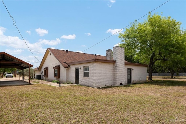 rear view of property with a lawn