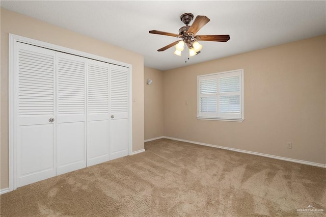 unfurnished bedroom with light colored carpet, ceiling fan, and a closet