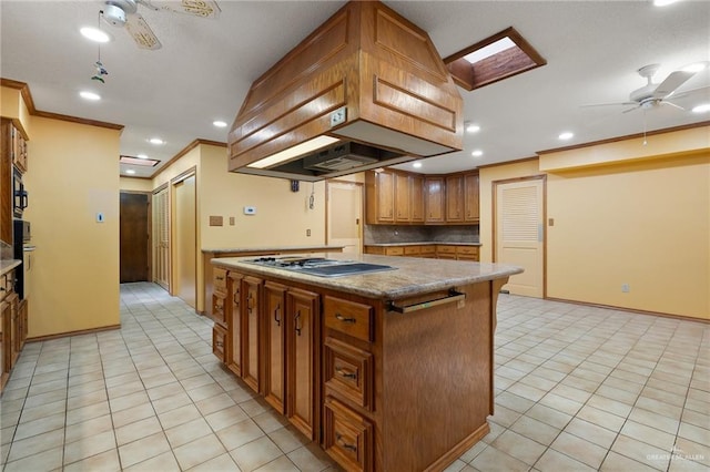 kitchen with crown molding, ceiling fan, and stainless steel gas stovetop