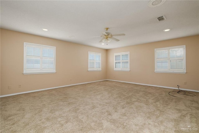 spare room with light carpet and ceiling fan