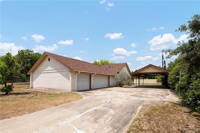 view of front facade with a garage, a front yard, and a carport