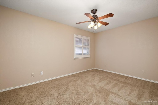 carpeted spare room with ceiling fan