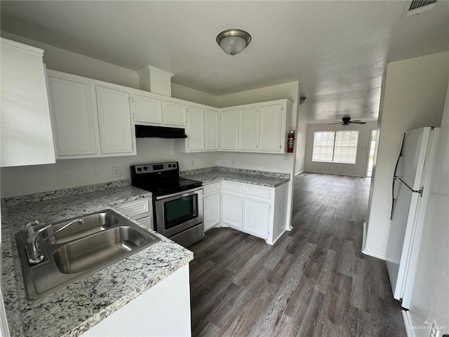 2504-2606 N M Rd, Edinburg, TX 78542 - kitchen featuring stainless steel electric range oven, freestanding refrigerator, under cabinet range hood, dark wood finished floors, and white cabinets