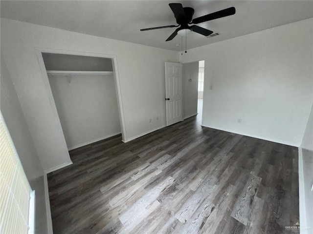 unfurnished bedroom featuring dark hardwood / wood-style flooring, a closet, and ceiling fan