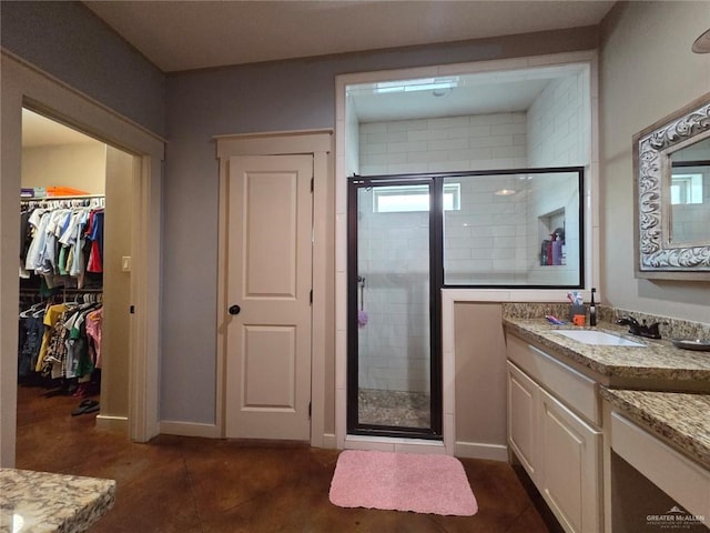 16637 W Barnes Ct, Harlingen, TX 78552 - full bath featuring vanity, a shower stall, a walk in closet, and baseboards