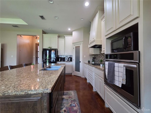 16637 W Barnes Ct, Harlingen, TX 78552 - kitchen featuring black appliances, a sink, tasteful backsplash, recessed lighting, and finished concrete floors