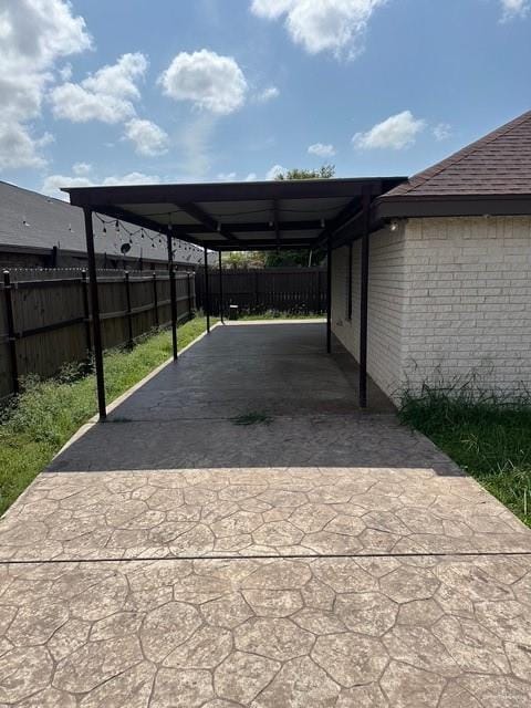 1502 W Kennedy Ave, Alton, TX 78573 - view of vehicle parking with driveway and a carport