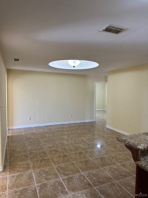 1502 W Kennedy Ave, Alton, TX 78573 - unfurnished room featuring baseboards and dark tile patterned floors
