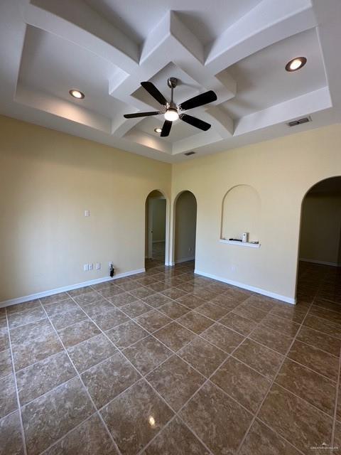 1502 W Kennedy Ave, Alton, TX 78573 - empty room featuring coffered ceiling, arched walkways, ceiling fan, dark tile patterned floors, and recessed lighting