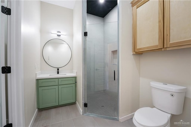 full bath featuring a stall shower, baseboards, vanity, and toilet