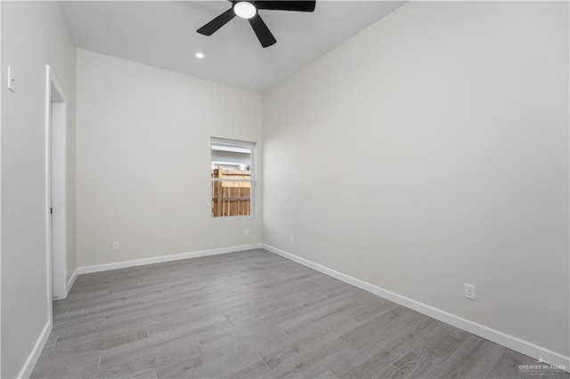 spare room with a ceiling fan, baseboards, wood finished floors, and recessed lighting