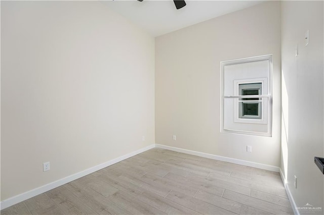 empty room with light wood-type flooring, ceiling fan, and baseboards