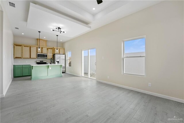 kitchen featuring light wood-style flooring, visible vents, baseboards, open floor plan, and appliances with stainless steel finishes