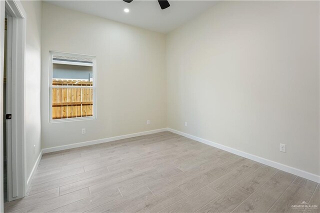 unfurnished room featuring a ceiling fan, recessed lighting, light wood-style flooring, and baseboards