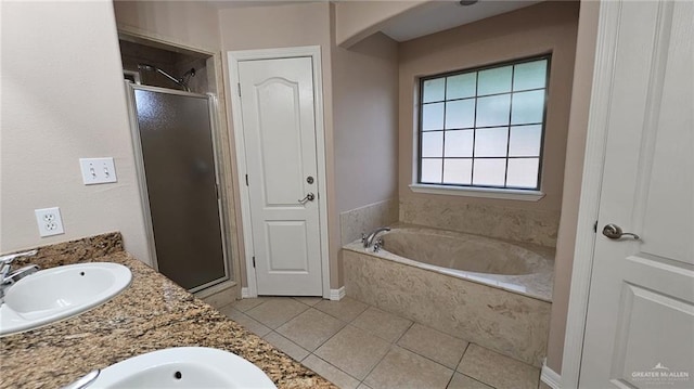 bathroom featuring plus walk in shower, tile patterned flooring, and vanity