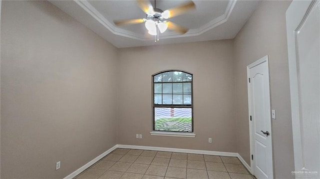 unfurnished room featuring ceiling fan, a raised ceiling, and light tile patterned floors