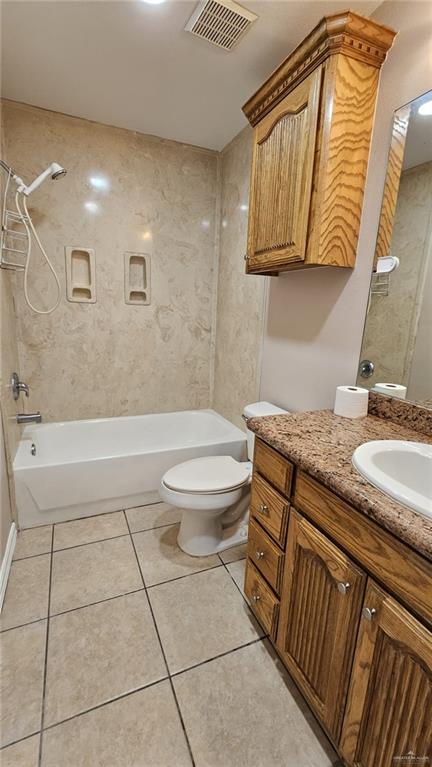 full bathroom featuring shower / washtub combination, tile patterned flooring, vanity, and toilet