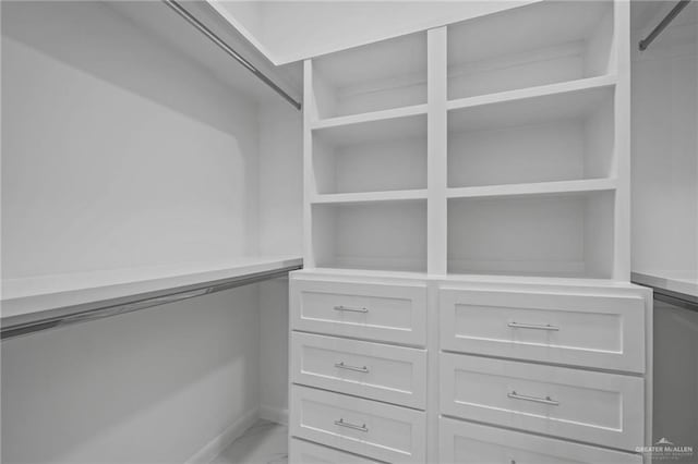 spacious closet featuring marble finish floor