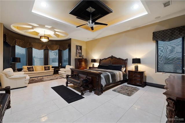 bedroom with light tile patterned floors, visible vents, baseboards, a ceiling fan, and a raised ceiling