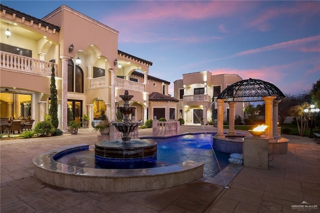 view of pool featuring a gazebo, a patio, and a pool with connected hot tub