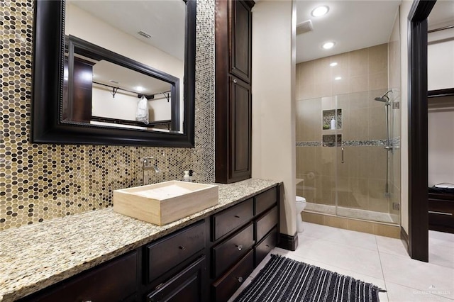 full bath featuring vanity, backsplash, toilet, and tile patterned floors