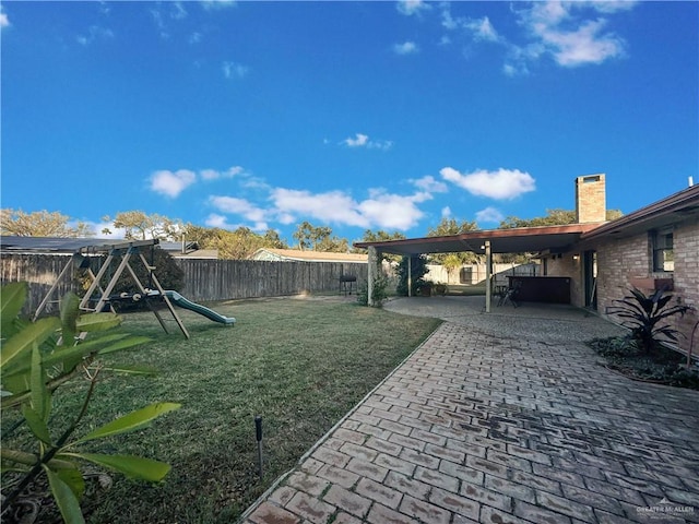 view of yard featuring a patio area and a playground