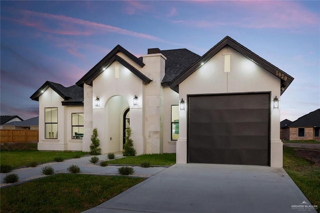 1920 Lime St, San Juan, TX 78589 - french provincial home with driveway, stucco siding, an attached garage, a shingled roof, and a front lawn