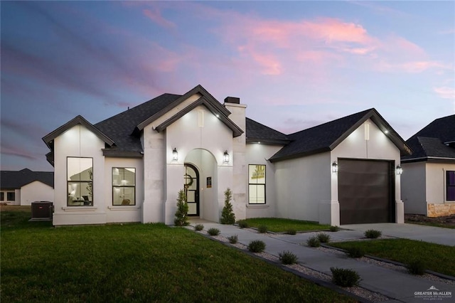 1920 Lime St, San Juan, TX 78589 - french country style house featuring a garage, a chimney, concrete driveway, a yard, and stucco siding