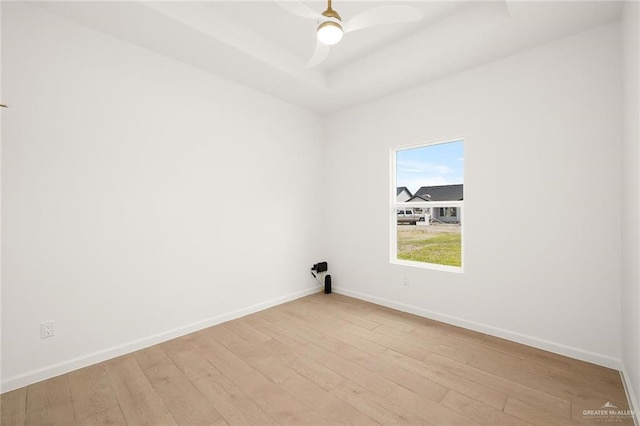 1920 Lime St, San Juan, TX 78589 - empty room with light wood finished floors, a ceiling fan, and a tray ceiling