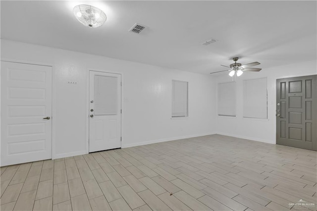 spare room featuring ceiling fan and light hardwood / wood-style floors