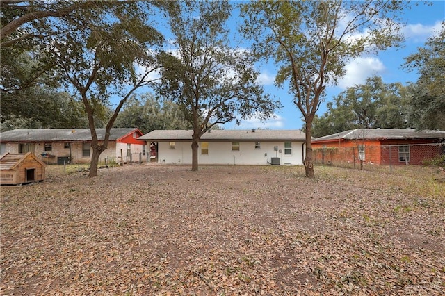 rear view of house featuring central AC unit