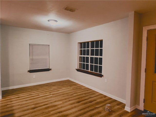 spare room with wood-type flooring