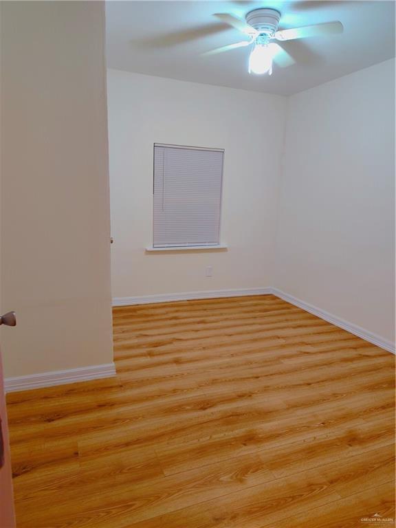 unfurnished room with ceiling fan and light hardwood / wood-style floors