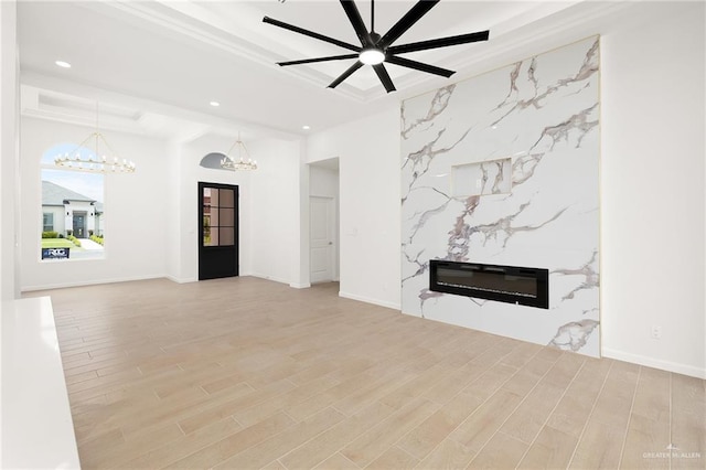 820 N Trinity St, Edinburg, TX 78541 - unfurnished living room featuring a chandelier, recessed lighting, wood finished floors, a premium fireplace, and ceiling fan