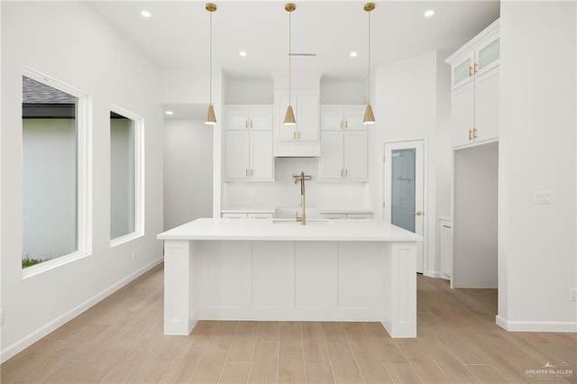 820 N Trinity St, Edinburg, TX 78541 - kitchen with light countertops, light wood-style floors, white cabinets, glass insert cabinets, and recessed lighting