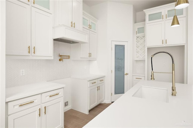 820 N Trinity St, Edinburg, TX 78541 - kitchen with tasteful backsplash, pendant lighting, white cabinetry, wood finished floors, and light countertops