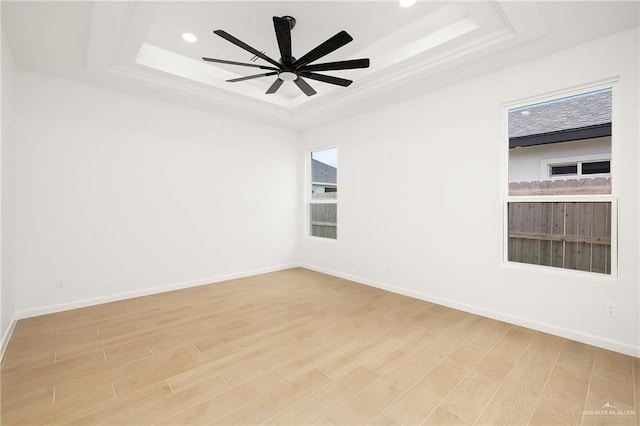 820 N Trinity St, Edinburg, TX 78541 - spare room featuring a raised ceiling, light wood finished floors, recessed lighting, and a ceiling fan