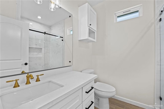 bathroom featuring hardwood / wood-style flooring, vanity, toilet, and walk in shower