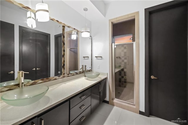 bathroom with tile patterned floors, an enclosed shower, and vanity