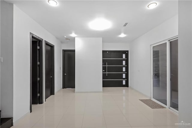 hallway featuring light tile patterned floors