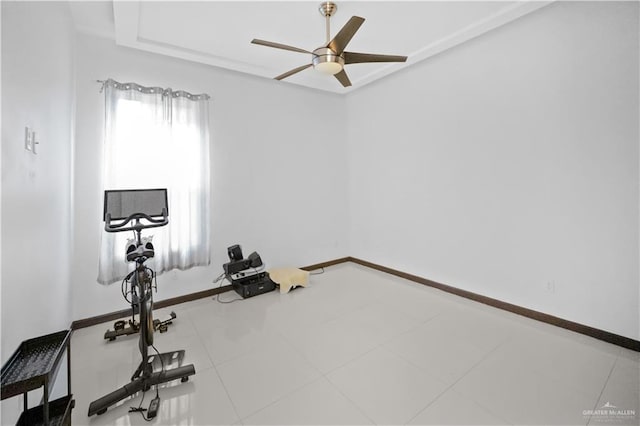 exercise area with ceiling fan and tile patterned floors