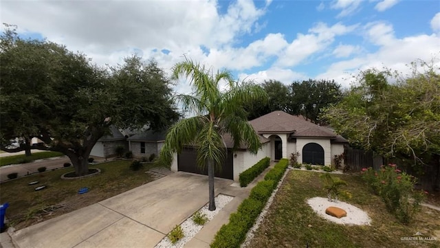 view of front of home with a garage and a front yard