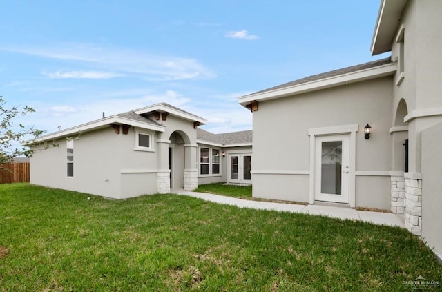 rear view of house with a yard