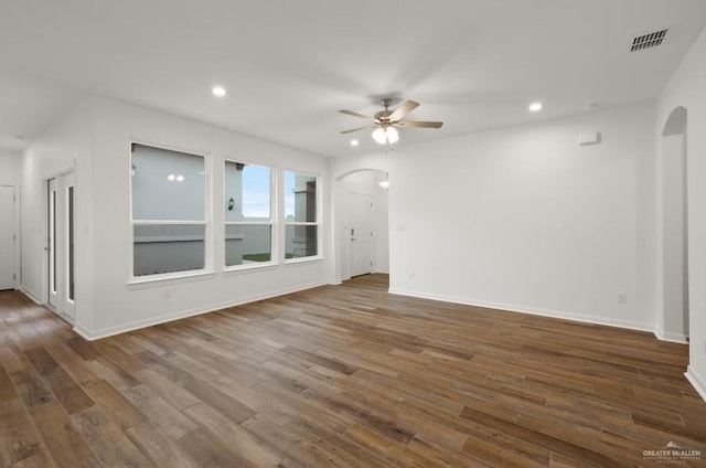 unfurnished living room featuring ceiling fan and dark hardwood / wood-style flooring