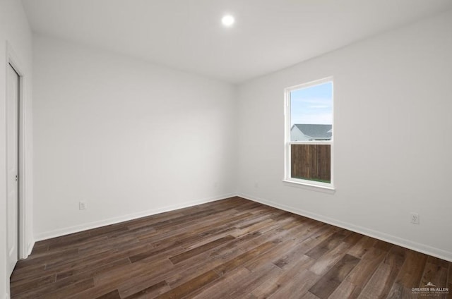 empty room featuring dark wood-type flooring