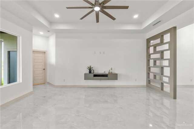 514 Oriole Dr, Los Fresnos, TX 78566 - unfurnished living room featuring a raised ceiling, a ceiling fan, recessed lighting, and light marble finish floors