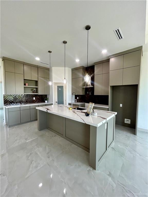 514 Oriole Dr, Los Fresnos, TX 78566 - kitchen featuring gray cabinetry, modern cabinets, a spacious island, backsplash, and light marble finish floors