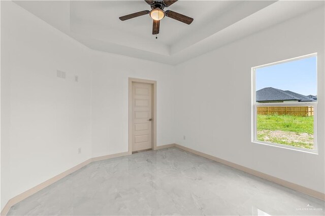 514 Oriole Dr, Los Fresnos, TX 78566 - unfurnished room with a tray ceiling and a ceiling fan
